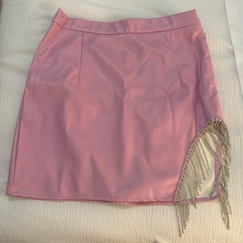 Large pink faux leather skirt with rhinestone fringe.